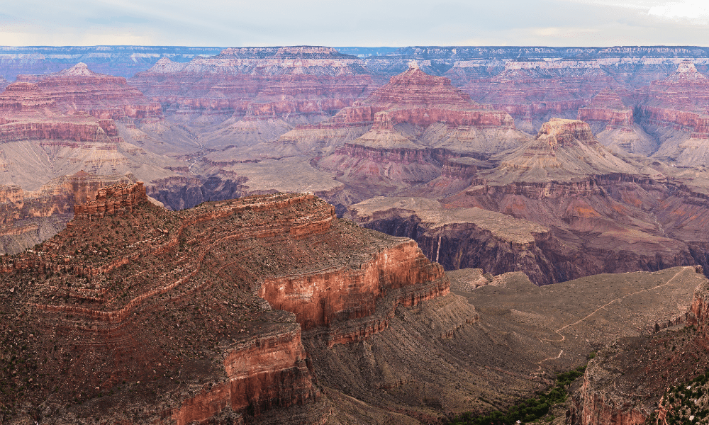 Panoramic view of the South Rim of the Grand Canyon, showcasing layered red rock formations and expansive canyon vistas.